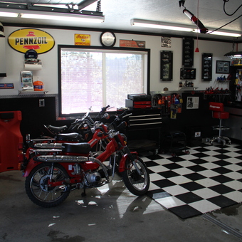 Organized Garage with Motorcycles, Tool Cabinets, and Decor - Anonymous