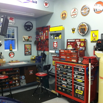 Organized garage with tool chests, wall signs, and workbench - Coz from Laflin, PA