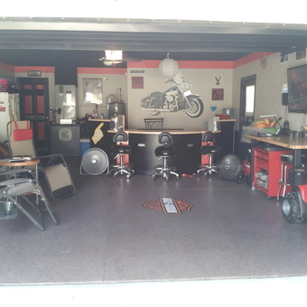 Custom garage with stools, tool cabinets, and decor - Guardog ManCave from Ocoee, FL