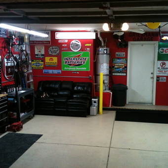 Organized garage with tool cabinets, signs, and sofa - Griesmann Garage from Las Vegas, NV