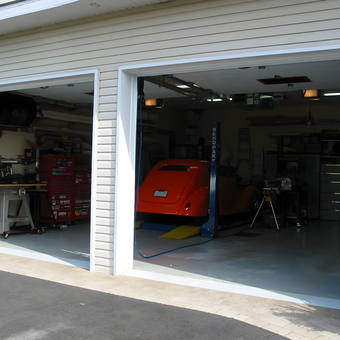 Organized garage with car lift and tool storage - racer from St-Felix-de-Valois, Quebec, Canada