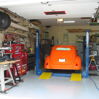 Organized garage with car lift, tool chests, and hot rod - racer from St-Felix-de-Valois, Quebec, Canada