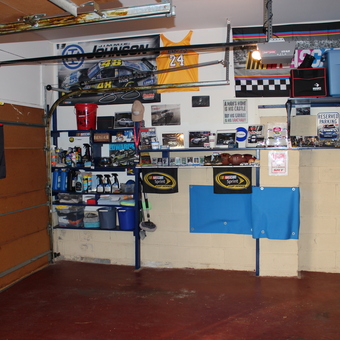 Organized garage with car care shelves and racing decor - RockSRT from Verona, NJ