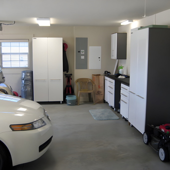 Organized garage with storage cabinets and workbench - RL from The Villages, FL