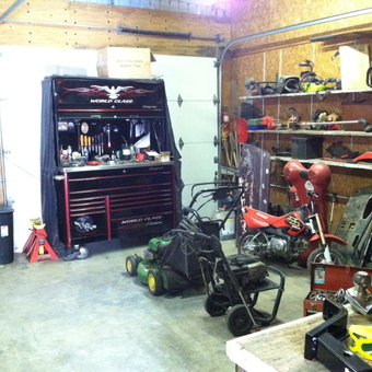 Organized garage with tool chest, shelves, and mini bike - Working man's garage from Longview, WA
