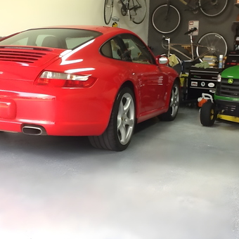 Organized garage with red car, mower, bikes, and tool chest - Bingjeep from North Canton, OH