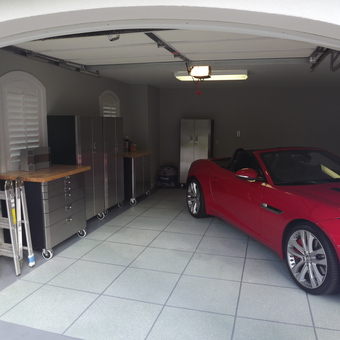 Modern garage with stainless cabinets and red car - RR from Savannah, GA