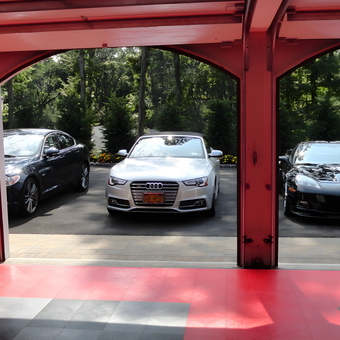 Red Garage Flooring and Luxury Cars Displayed - Bill Fuhrmann from Oyster Bay, NY