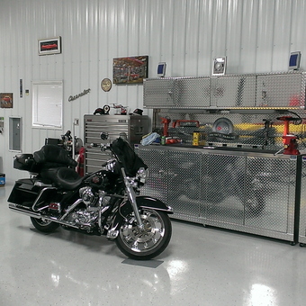 Diamond Plate Cabinets and Motorcycle in Organized Garage - Anonymous