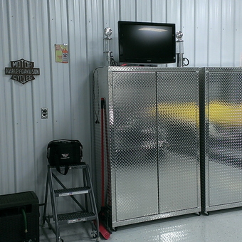 Diamond Plate Cabinets and Garage Decor with TV - Anonymous
