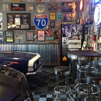 Classic Car Garage with Retro Decor and Bar Stools - Dixon