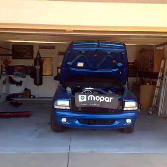 Organized garage with blue truck, tools, and decor - Phoenix from Scottsdale, AZ