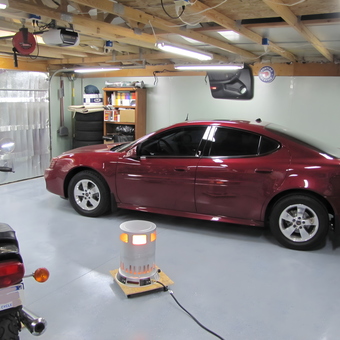 Organized garage with red car, motorcycle, and storage - Nathan from Linden, MI