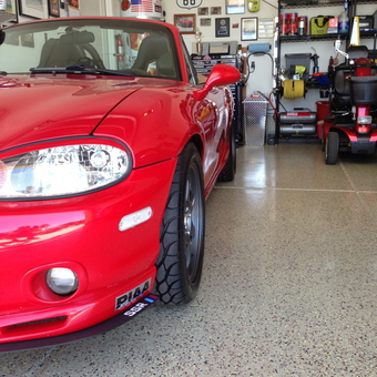 Red sports car and organized garage with wall decor - Kurt from La Mesa, CA