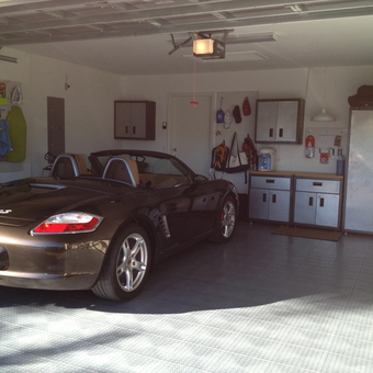 Organized garage with cabinets, pegboard, and Porsche - Michael from Boyton Beach, FL