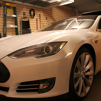 Organized garage with tools, ladder, and Tesla - Eddie from Mesa, AZ