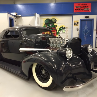 Classic Custom Hot Rod with Whitewall Tires in Garage - Anonymous