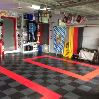 Organized garage with checkered flooring and wall decor - Wally G. from Coral Springs, FL