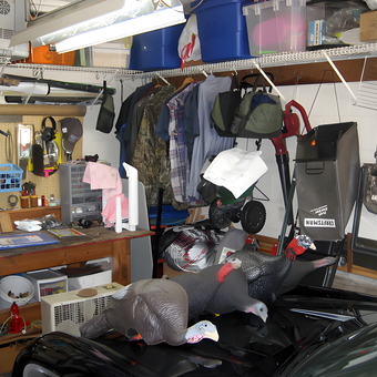 Organized garage with storage bins, workbench, and hunting gear - tix from tampa, FL