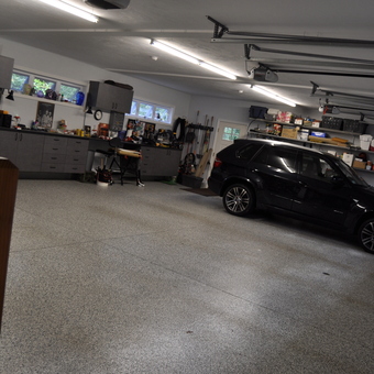 Organized garage with cabinets, workbench, and SUV - Shipwreck from Milton, MA