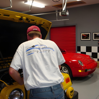 Organized garage with red car, checkerboard walls, and storage - Jay from Blythewood, SC