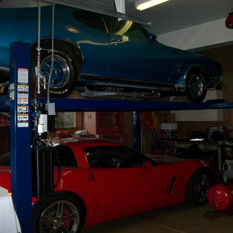 Home garage with car lift, classic cars, and tools - Paulette Guiedo from Lemont, IL