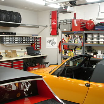 Organized garage with tool cabinets, wall storage, and cars - George from Clover, SC