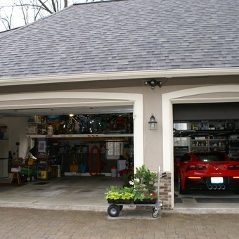Organized garage with car lift, shelving, and Corvette - jerry carguy from pinckney, MI