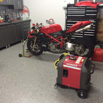 Organized garage with red Ducati motorcycle and tool storage - Jim from Rochester, MN