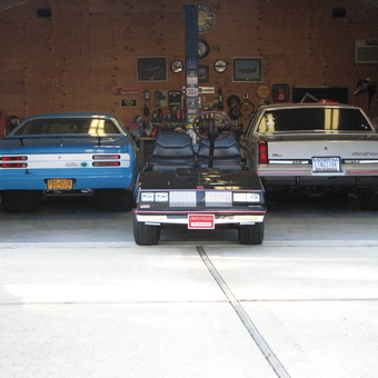 Classic Cars, Golf Cart, and Wall Decor in Garage - Hemi Tony