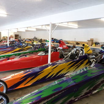 Colorful Dragsters Parked in Spacious Garage - Need for speed