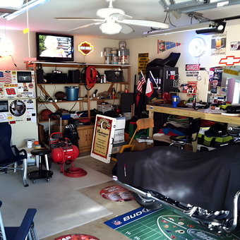 Organized garage with workbench, fridge, and motorcycle - FrenchMan from The Woodlands, TX