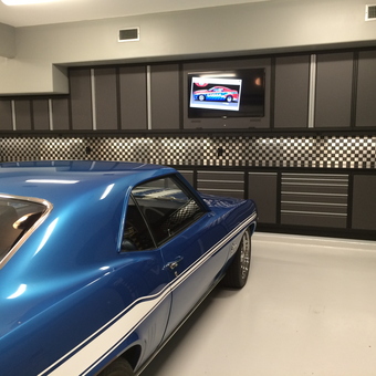 Modern garage with cabinets and checkered backsplash - Speedy's Garage from Friendswood, TX