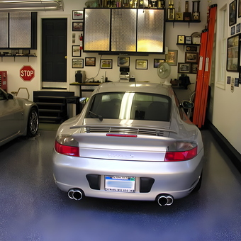 Organized garage with sports cars, cabinets, wall decor - Craig C from Westbrook, CT