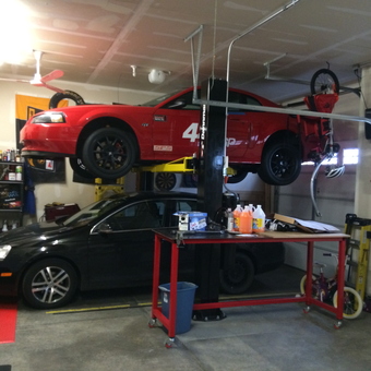 Organized garage with car lift, workbench, and storage - Auggy from Oswego, IL
