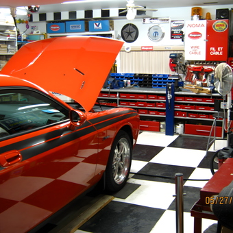 Organized garage with red tool cabinets and muscle car - Mike from Laval Canada