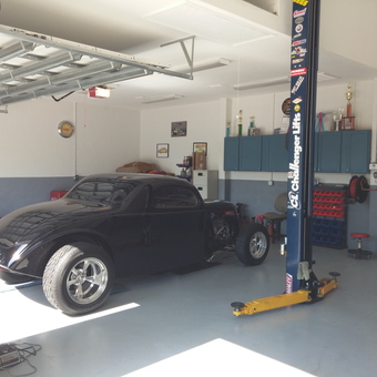 Organized garage with car lift, cabinets, and classic car - Jeff from Brandon, FL