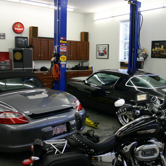 Organized garage with car lift, tool cabinets, and vehicles - Jerry Forthofer from Rockwell, NC