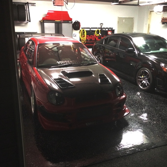 Organized garage with sports cars and storage racks - A. W. from North Potomac, MD