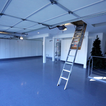 Organized garage with cabinets, attic ladder, and epoxy floor - Bill McIntire from San Diego, CA