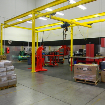 Industrial garage with yellow crane, red cabinets, and tools - Boss Man from Sparks, NV