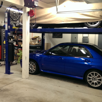 Organized garage with car lift, tool chests, and bikes - Tyler from Portland, OR
