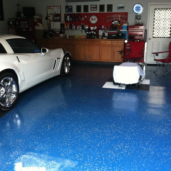 Organized garage with white Corvette and blue floor - Generations from Corbin, KY