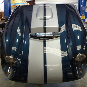 Classic car with blue and white stripes in garage - john from livermore, CA
