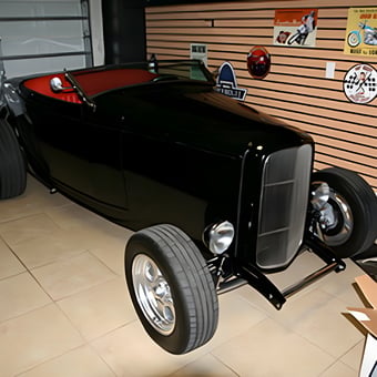 Classic Black Hot Rod in Tiled Garage with Wall Signs - Anonymous