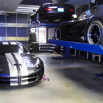 Modern garage with car lift and sports cars - TooBlue Racing