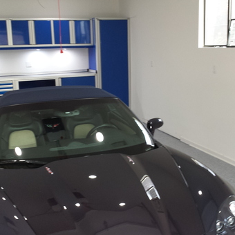 Modern garage with blue cabinets and sports car - Dave from Highland, MD