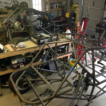 Off-road vehicle frames and tools in a busy garage - BMan from Marietta Ga, GA