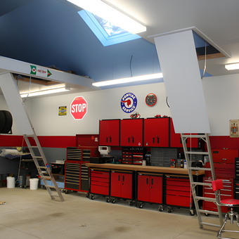 Organized garage with red cabinets and stop signs - Perry from Woodbury, NY