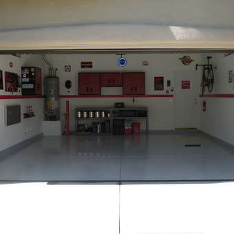 Organized garage with red cabinets and wall decor - Jim from Las Vegas, NV